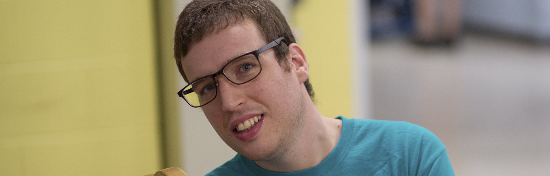 Man with glasses smiling for photo