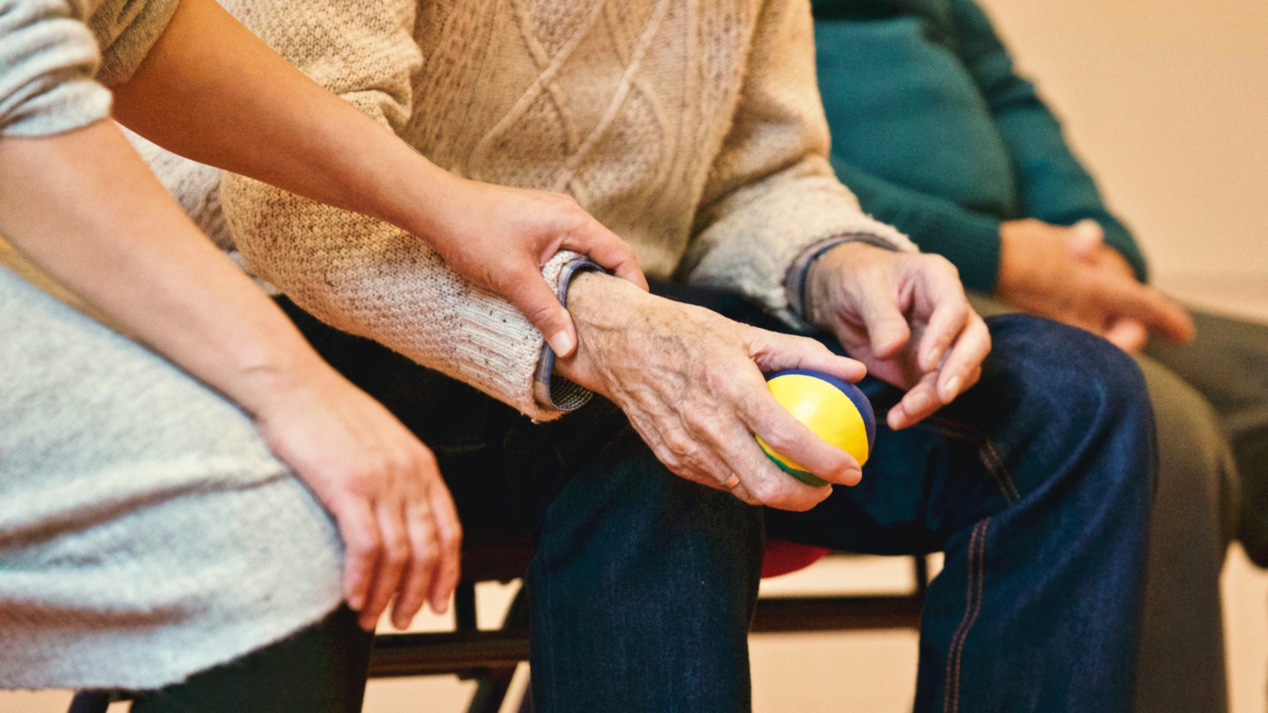 Woman grabbing elderly mans hand