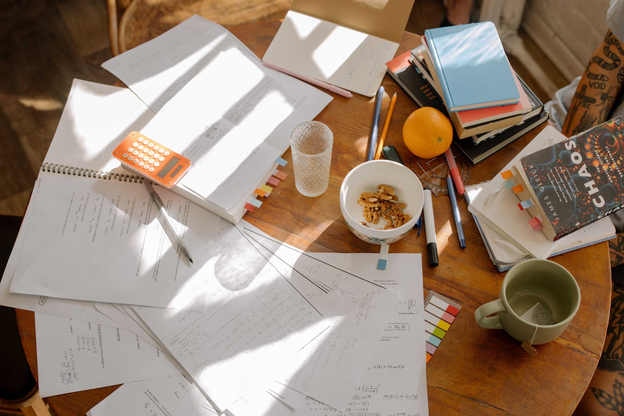 Picture of Coffee Table with papers strewn all over it and empty mugs