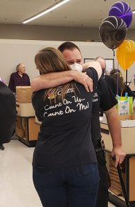 Two Employees Hug One Another at a Party