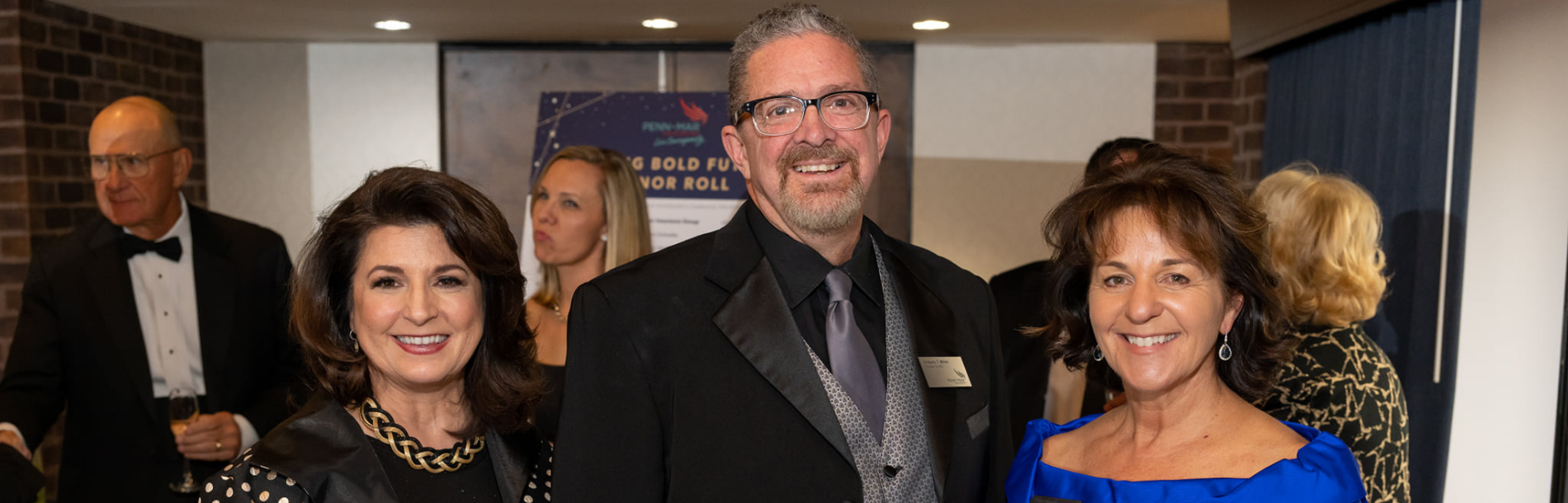 Jackie, Greg, and Kathy smiling at the Gala