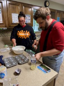 A DSP with a man she's supporting to help make cupcakes. 