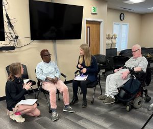 Two students and two Penn-mar individuals talking.