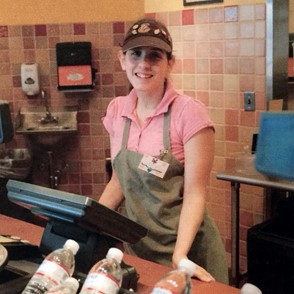 Stephanie behind the register at Panera smiling.