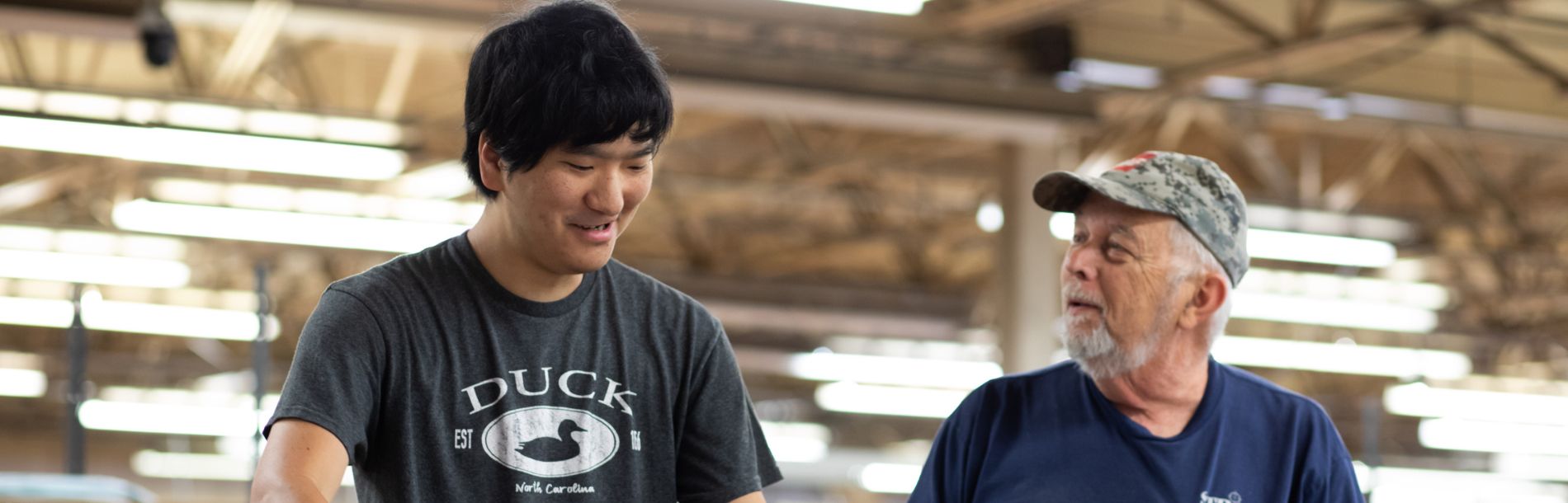 2 men working in a warehouse.