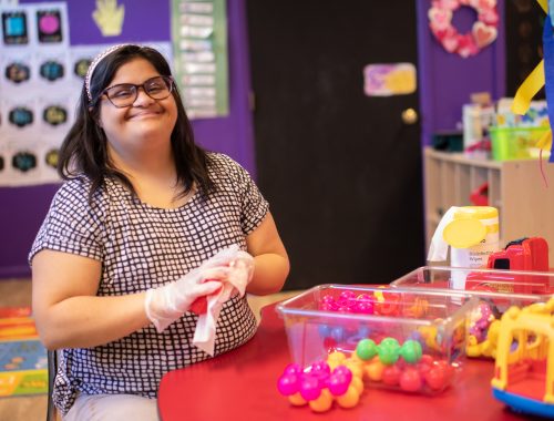 Sunya cleaning toys at her job