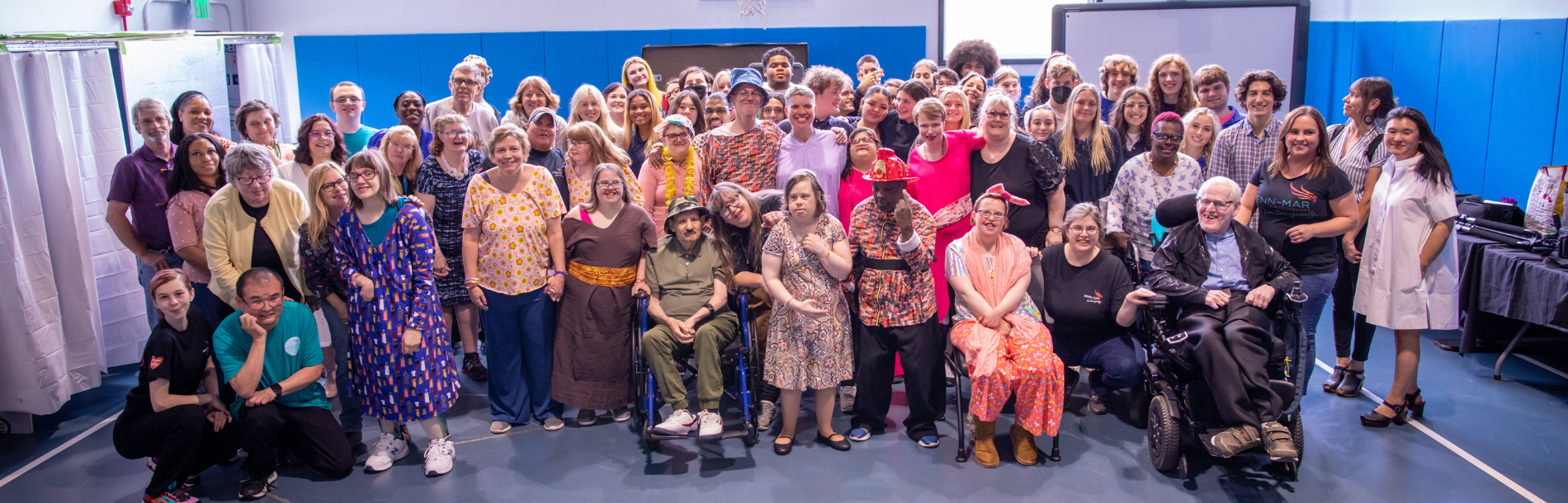 A large group photo in a gym.