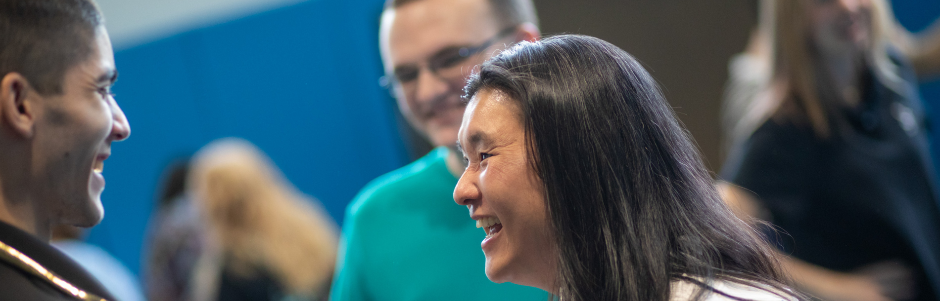 A woman and a man smiling and laughing.