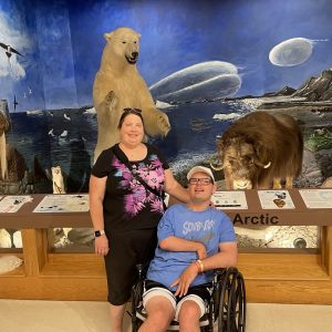 Melissa and Josh in front of a nature exhibit.