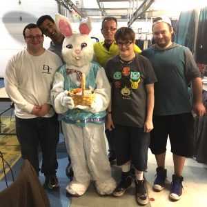 A group of 5 people and someone in a bunny costume.
