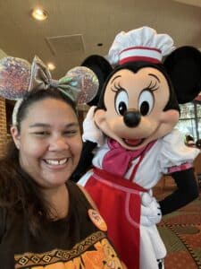 Lauren at disney world with minnie mouse behind her. 