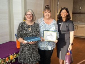 Jen Skelly poses with her diploma alongside Cindy Kauffman, Senior Advisor, ANCOR and Gabrielle Sedor, COO and Foundation Director, ANCOR 