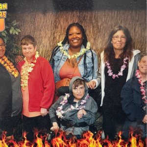 Detra poses with people she supports.