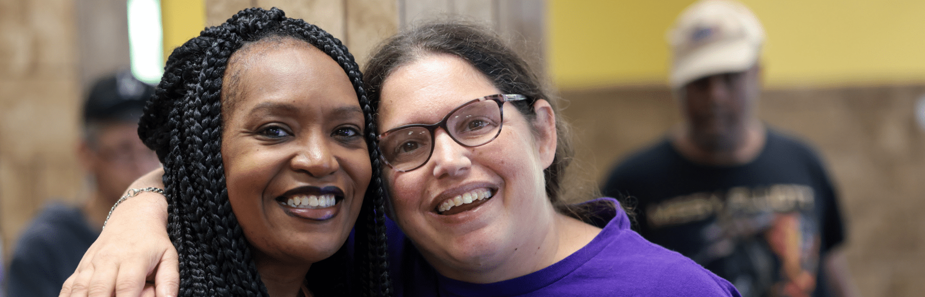 A DSP and a woman we support with her arm around her.