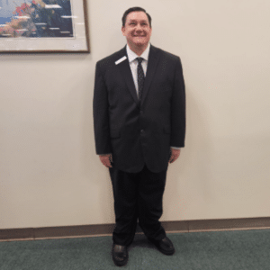 Tim O'Neil poses in a suit at work.