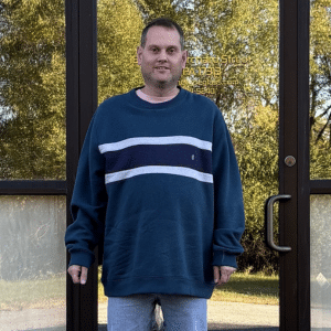 Eddie LaRicci poses in front of his workplace.