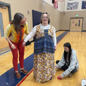 A Penn-Mar model stands while Jemicy designers take measurements on her outfit.