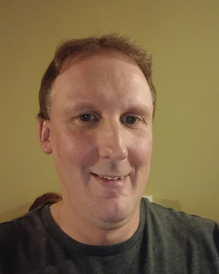 Headshot of Joseph smiling.