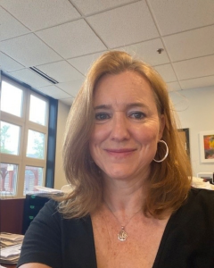 Headshot of Kelly smiling